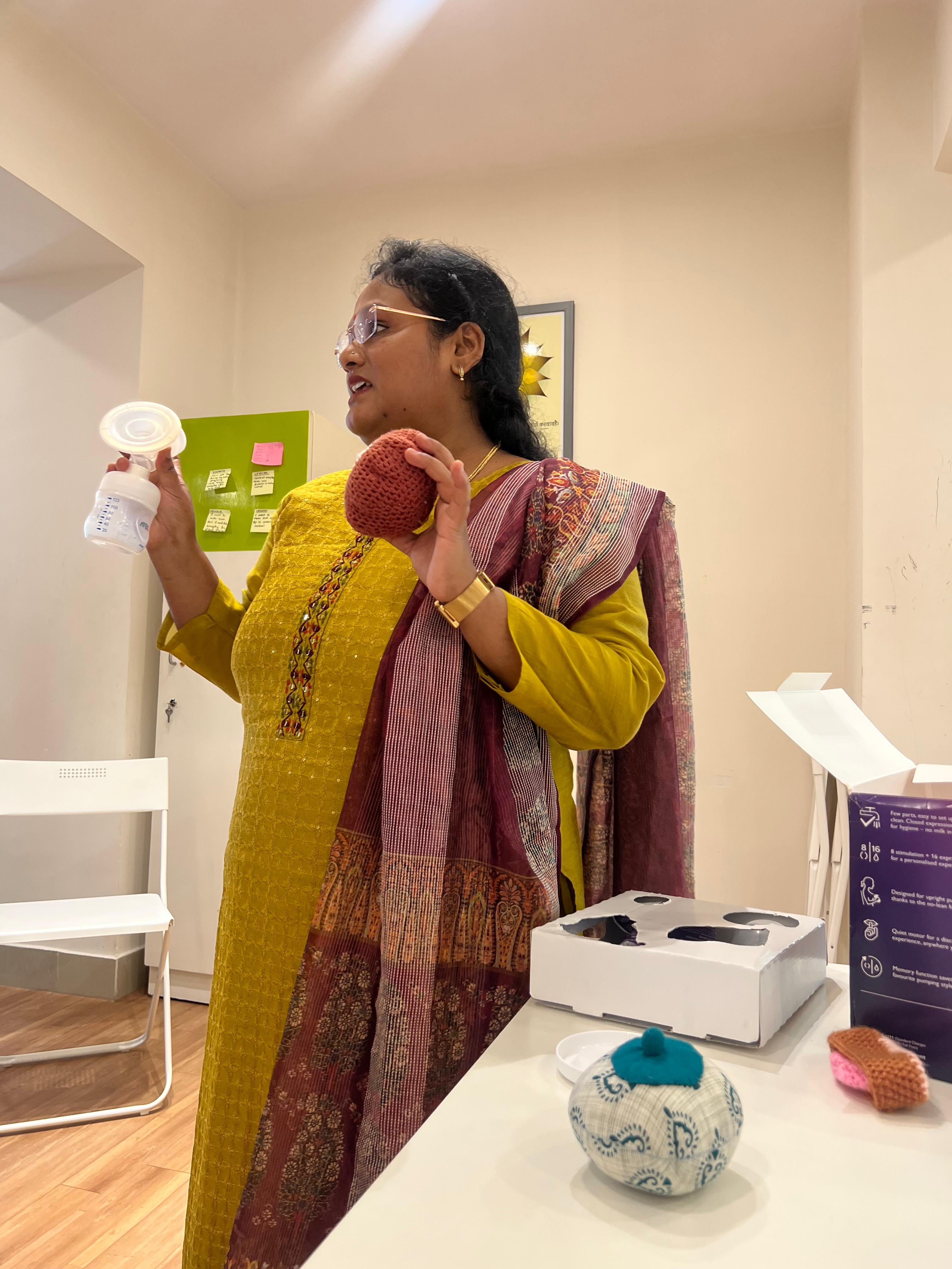 Mother breastfeeding during breastfeeding week, highlighting the importance of breastfeeding, in the Aura Breastfeeding Workshop.